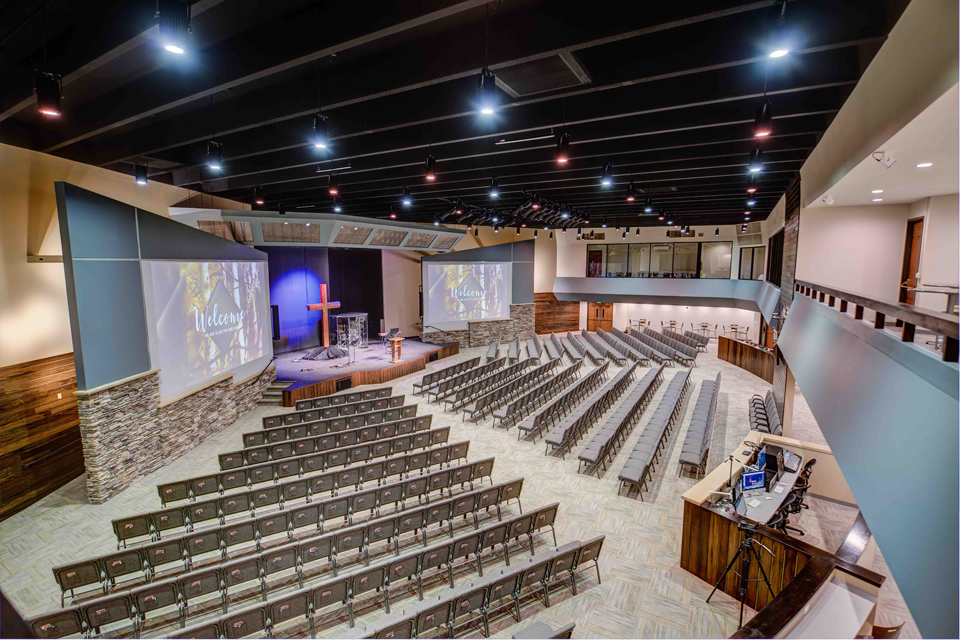 Picture of Pulpit Rock Auditorium Renovation, pendant lights, large worship seating, balcony viewing area in churches, glass partition in church assembly, exposed rafters in church interior, modern church sanctuary, wood trim in interior church building, modern church auditorium, multiple level church auditorium, church mezzanine