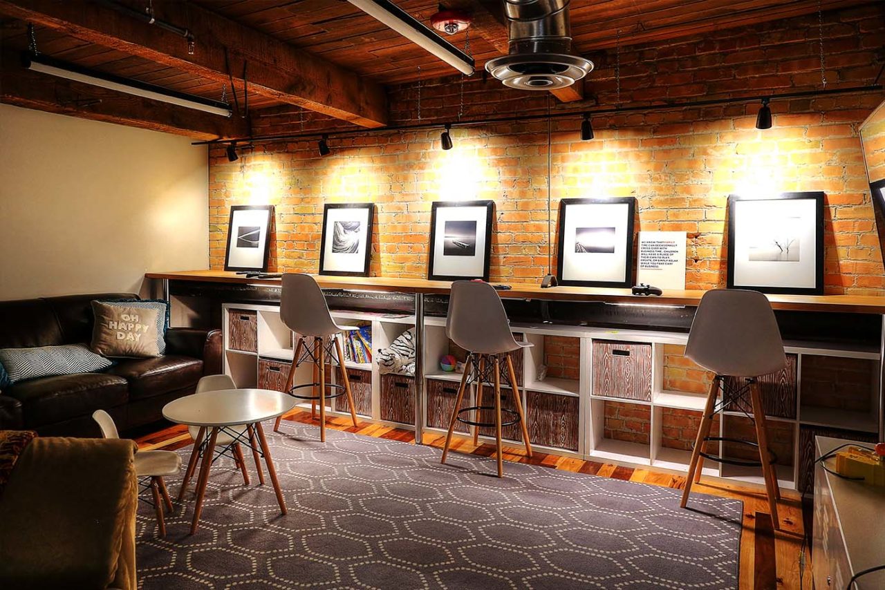 Cozy waiting area, warm spot lights, brick interior walls, warm color scheme