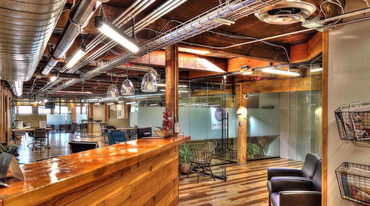 Family Business Center, Ogden, UT, exposed ductwork, pendant light strips, pendant lights, exposed woodwork, warm color scheme office space, glass partition, window privacy glass