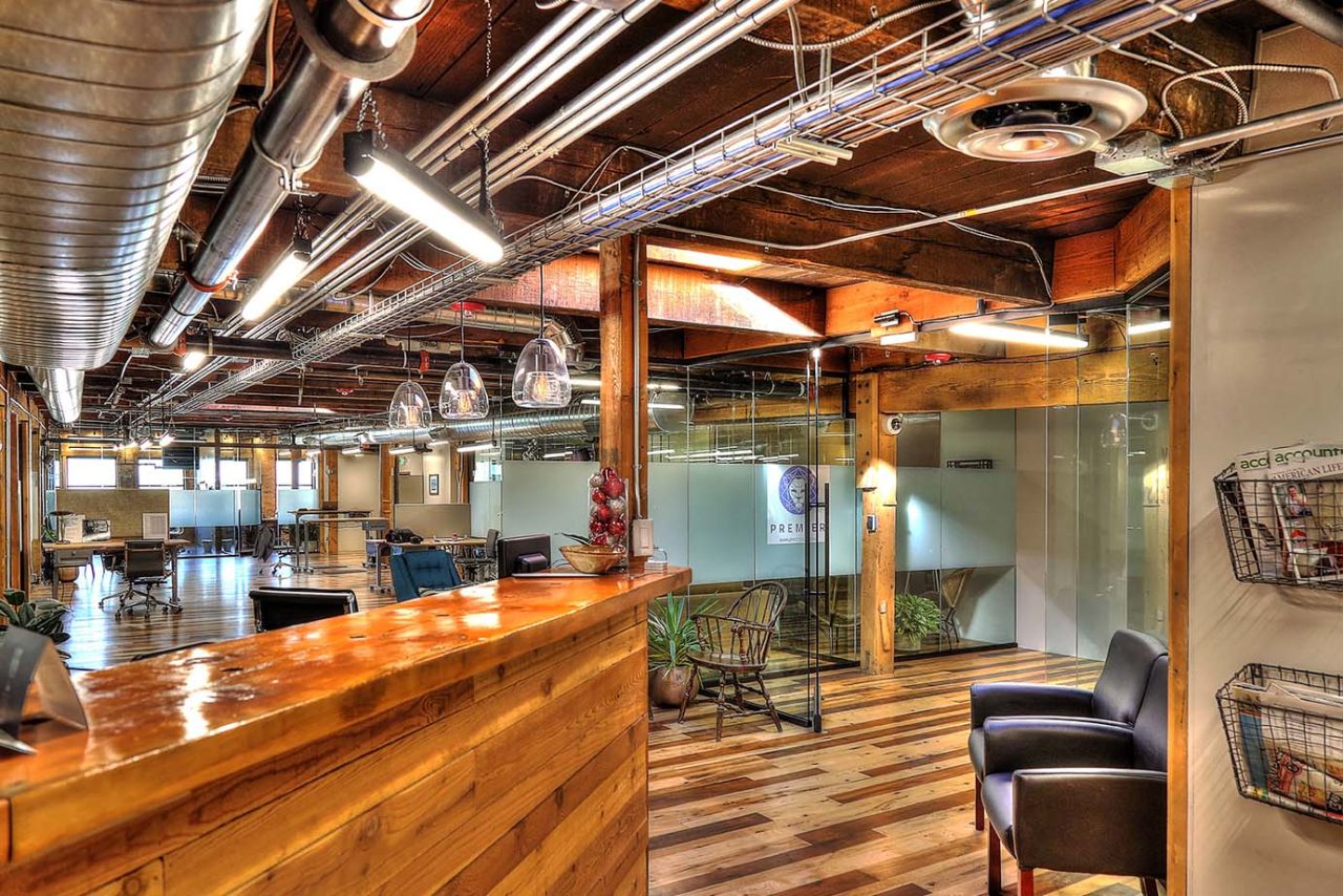 Family Business Center, Ogden, UT, exposed ductwork, pendant light strips, pendant lights, exposed woodwork, warm color scheme office space, glass partition, window privacy glass