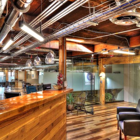 Family Business Center, Ogden, UT, exposed ductwork, pendant light strips, pendant lights, exposed woodwork, warm color scheme office space, glass partition, window privacy glass