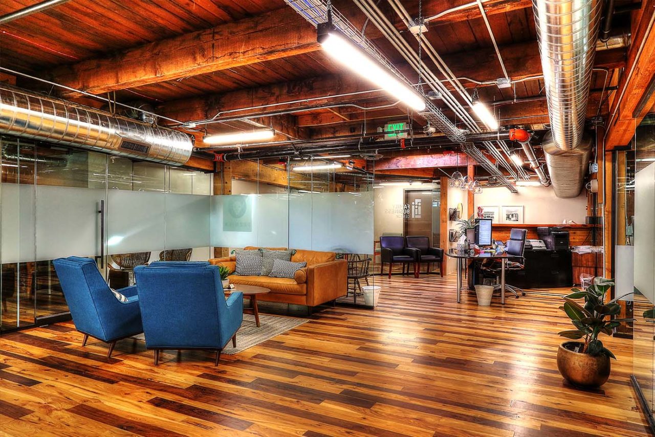 Family Business Center, Ogden, UT, exposed ductwork, pendant light strips, pendant lights, exposed woodwork, warm color scheme office space, glass partition, window privacy glass