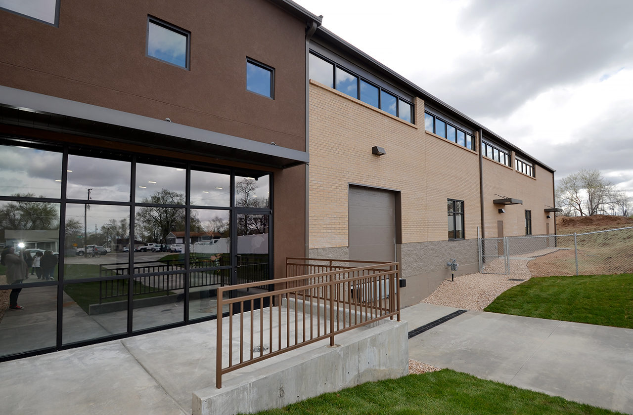 Catholic Community Services warehouse addition, brick warehouse exterior, stucco warehouse exterior, modern warehouse exterior ideas, storefront warehouse, warehouse unit with lots of windows