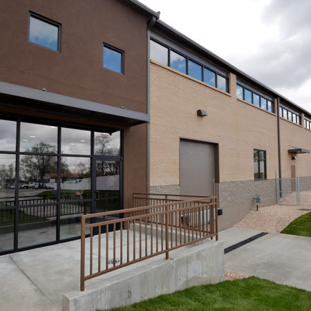 Catholic Community Services warehouse addition, brick warehouse exterior, stucco warehouse exterior, modern warehouse exterior ideas, storefront warehouse, warehouse unit with lots of windows