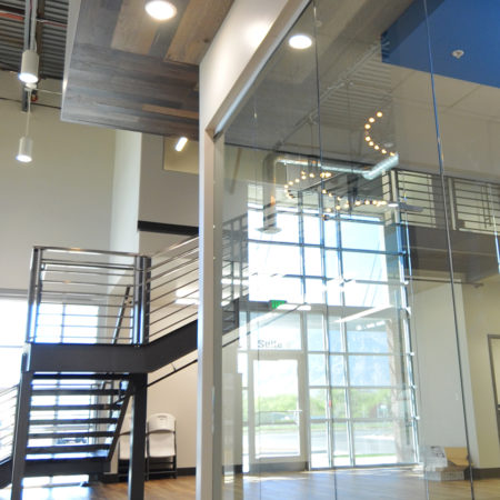 Hawx Pest Control corporate headquarters, tenant improvement, natural light building, metal stairs with railing, exposed ductwork interior building, canned lighting, pendant lighting, full glass interior walls