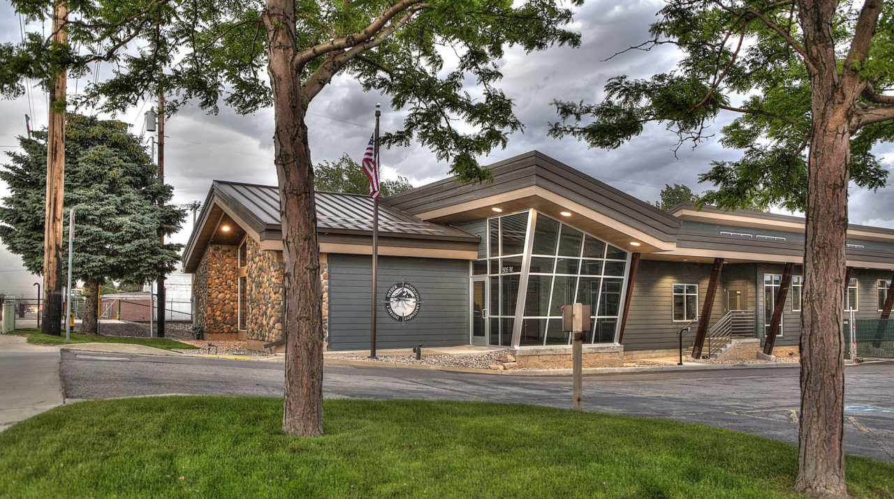 modern office buildings, diagonal exterior lines, storefront entrance, neutral exterior color scheme, exposed wood columns, exposed wood supports, metal roofing