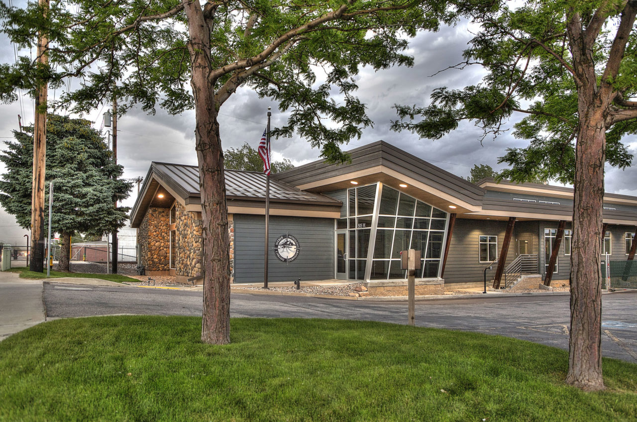 modern office buildings, diagonal exterior lines, storefront entrance, neutral exterior color scheme, exposed wood columns, exposed wood supports, metal roofing