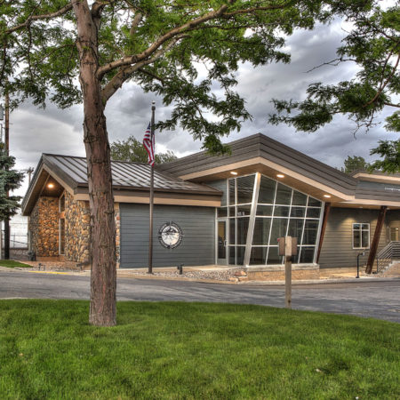 modern office buildings, diagonal exterior lines, storefront entrance, neutral exterior color scheme, exposed wood columns, exposed wood supports, metal roofing