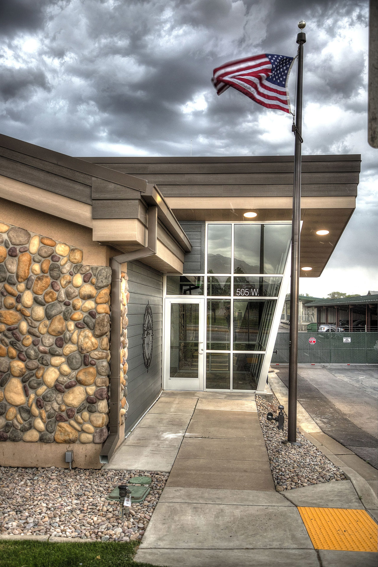 Wood siding, canned lights, stone exterior, neutral exterior color scheme