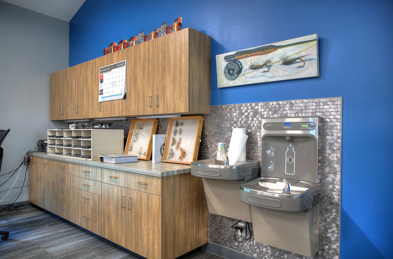 wood cabinetry, metal backsplash